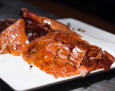 Komodo signature dishes Peking Duck, Tuna & Toro Roll, Lobster Dynamite, Wagyu Skirt Steak Tacos